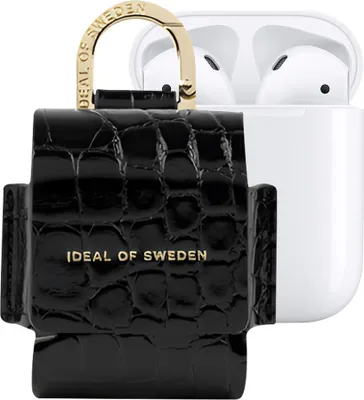 A black crocodile-textured case for AirPods is shown next to an open white AirPods charging case.