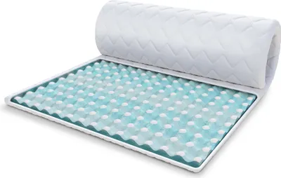A mattress topper is shown partially unrolled on a white background.