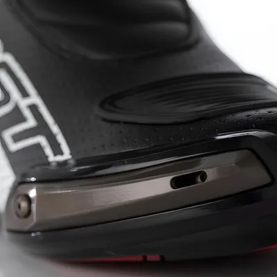 A close-up view of a black motorcycle boot.