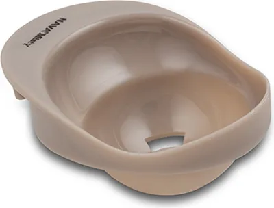 A close-up, studio shot of a beige plastic object with a concave interior and a cutout at the bottom.
