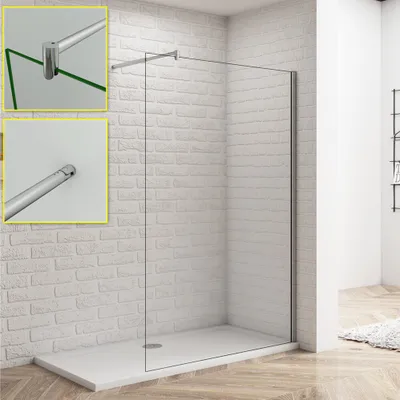 A modern shower enclosure with a glass wall and a white shower tray, set against a white brick wall.
