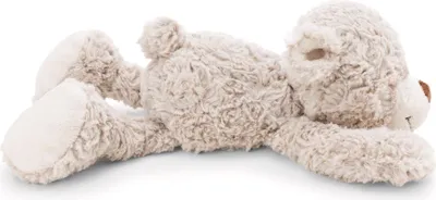 A plush teddy bear lying on its side against a white background.