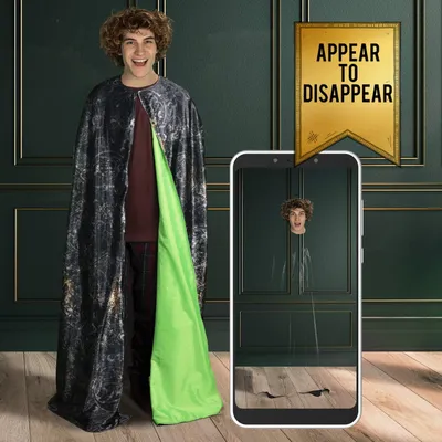 A young man wearing a costume cape is shown, with a smartphone displaying a trick where his body appears to disappear.