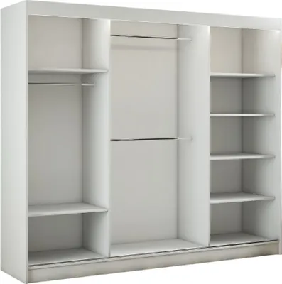An empty white wardrobe with three sliding doors and shelves.