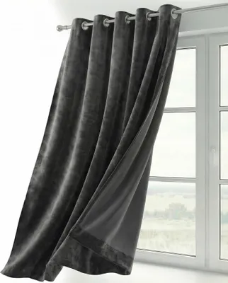 A dark gray velvet curtain is shown hanging from a curtain rod in front of a window.