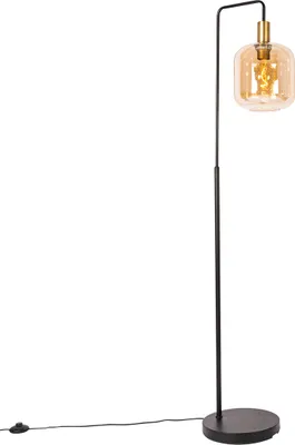 A black floor lamp with a brass accent and an amber glass shade, shown against a white background.