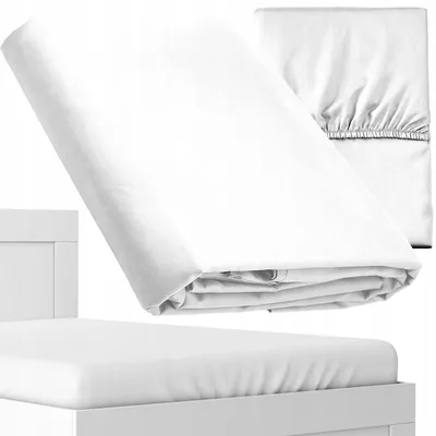 A white fitted sheet is folded and placed on a white bed frame. Another fitted sheet is folded in the background.