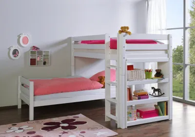 A white bunk bed with pink bedding and a small bookshelf attached.