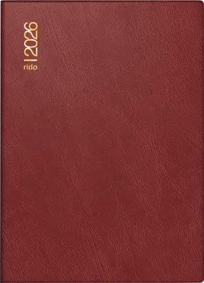A close-up view of a red planner with gold lettering.