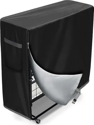 A black protective cover is partially unzipped, revealing the metal frame of a foldable bed inside.