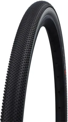 A close-up studio shot of a black bicycle tire against a white background.