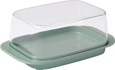 A butter dish with a sage green base and a clear lid, shown from a slightly elevated angle against a white background.