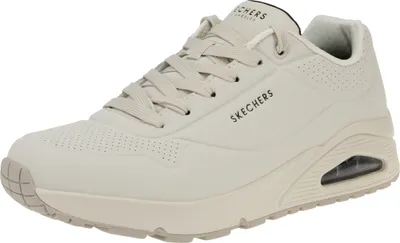 A side view of a beige Skechers sneaker.