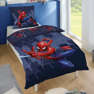 A child's bed with Spiderman-themed bedding.