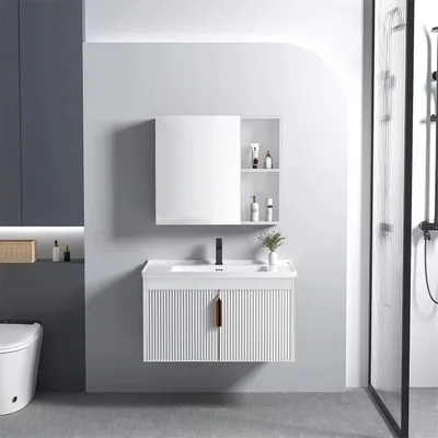 A modern bathroom vanity set with a sink and mirror, next to a toilet and shower.