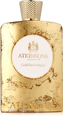 A perfume bottle with a gold-colored, textured exterior and a white label.