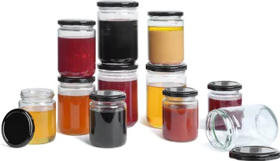 A collection of glass jars filled with various colorful contents, such as jams, sauces, and spreads, arranged on a white background.