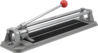 A manual tile cutter on a light gray surface.