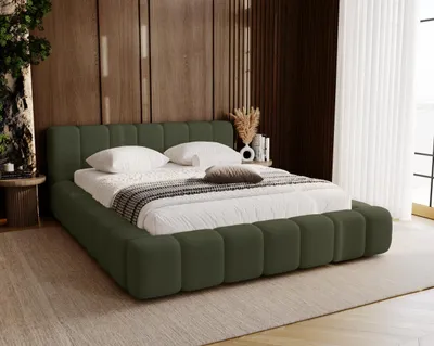 A bedroom scene featuring a green upholstered bed.
