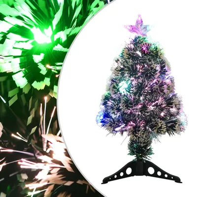 A fiber optic Christmas tree with multicolor lights and a star topper, set against a white background with a blurred green and white fiber optic display on the left.