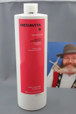 A bottle of Medavita shampoo is shown in front of a blurred background image of a man with a beard and hat.