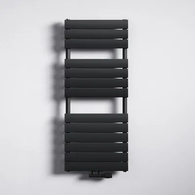 A black radiator is mounted on a white wall.