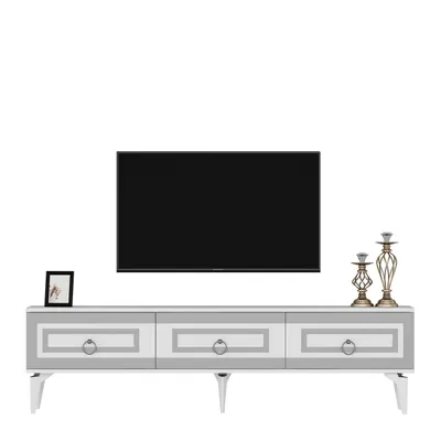 A TV stand with a television mounted above it, and decorative items on the stand.