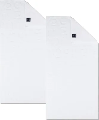 Two white towels are laid out on a white background.