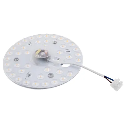 A circular LED light module with a white base and multiple small LED lights arranged in concentric circles. A small central component with wires is visible. A white cable with blue and brown wires extends from the module to a white connector.