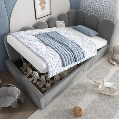 A child's bed with storage, showing stuffed animals inside the storage compartment.