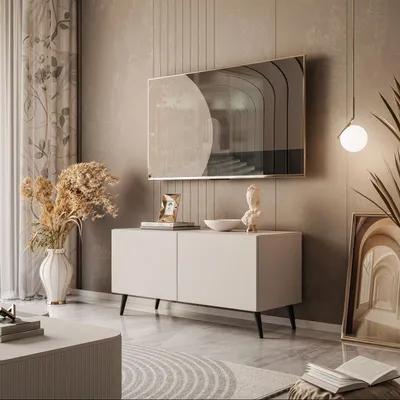 A modern living room with a TV stand and artwork.