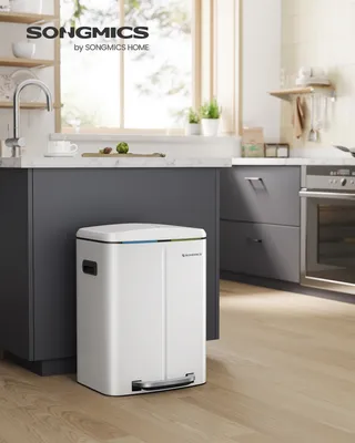 A white pedal bin is placed in a modern kitchen setting.