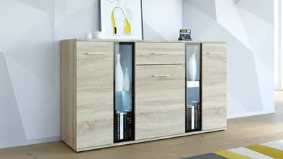 A modern sideboard with glass doors and drawers, displayed in a well-lit room with a geometric patterned wall.