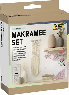 A product box for a macrame set, displayed in a studio-like setting with decorative elements.