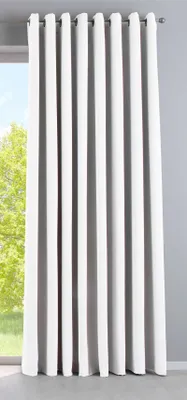 A white curtain hanging in front of a window.