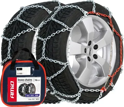 A pair of snow chains on tires, with a carrying bag in the foreground.
