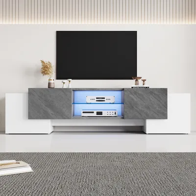 A modern TV stand with a television mounted above it, set in a clean, minimalist room.