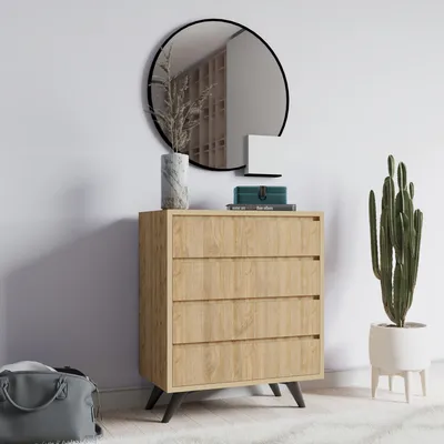 A dresser with a mirror and a plant in a room.