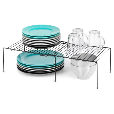 A metal shelf organizer with stacked plates, cups, and bowls on a white background.