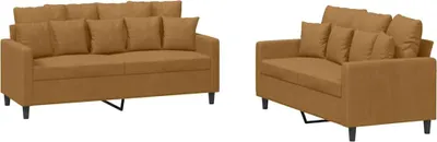 A set of two brown velvet sofas with pillows, shown against a white background.