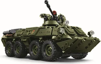A green toy model of a military vehicle, likely a building block set, is shown against a white background.