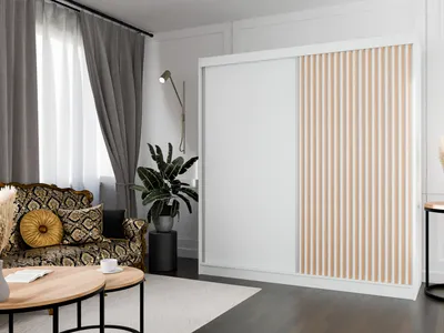 A living room scene featuring a large sliding door wardrobe.