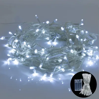 A bundle of white LED string lights coiled on a reflective surface.