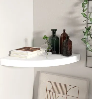 A white corner shelf with decorative items.