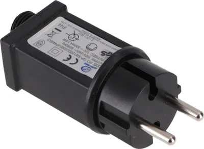 A close-up studio shot of a black power adapter with a European plug.