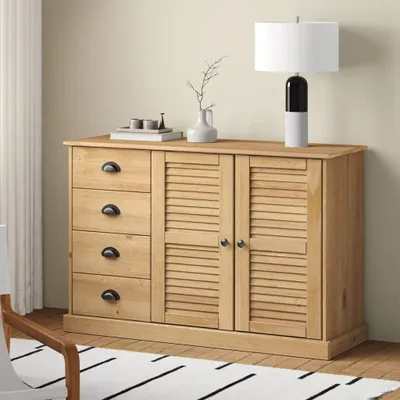 A wooden sideboard with drawers and louvered doors, placed against a light-colored wall.