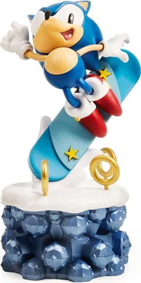 A figurine of Sonic the Hedgehog snowboarding on a blue board, with a rocky base.