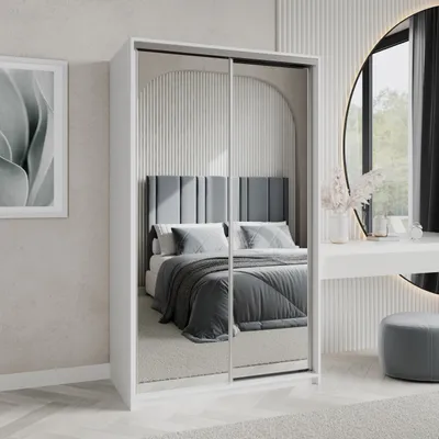 A bedroom scene with a wardrobe, bed, and vanity table.