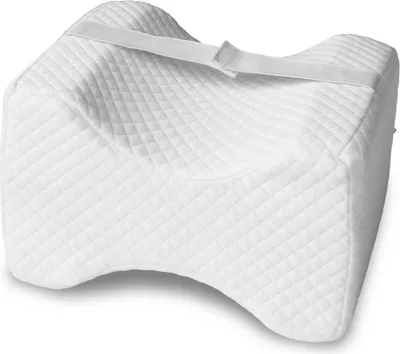 A white, quilted knee pillow with a strap across the top, shown on a white background.