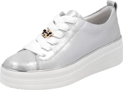 A studio shot of a single silver sneaker with a platform sole.